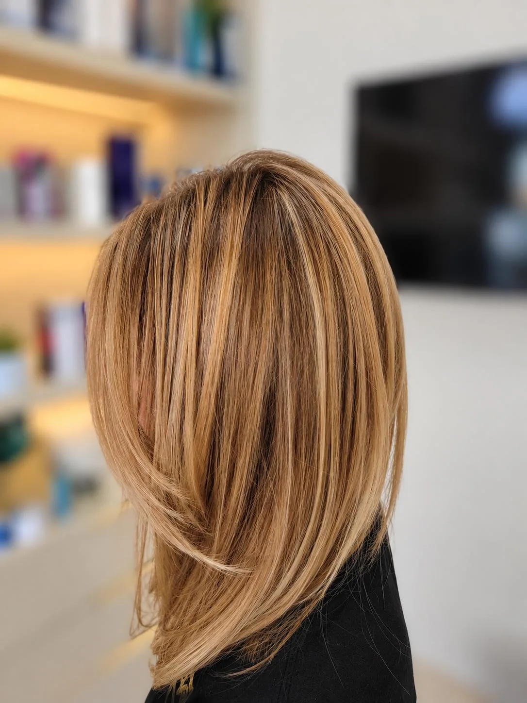 Honey blonde layered bob seen from the back
