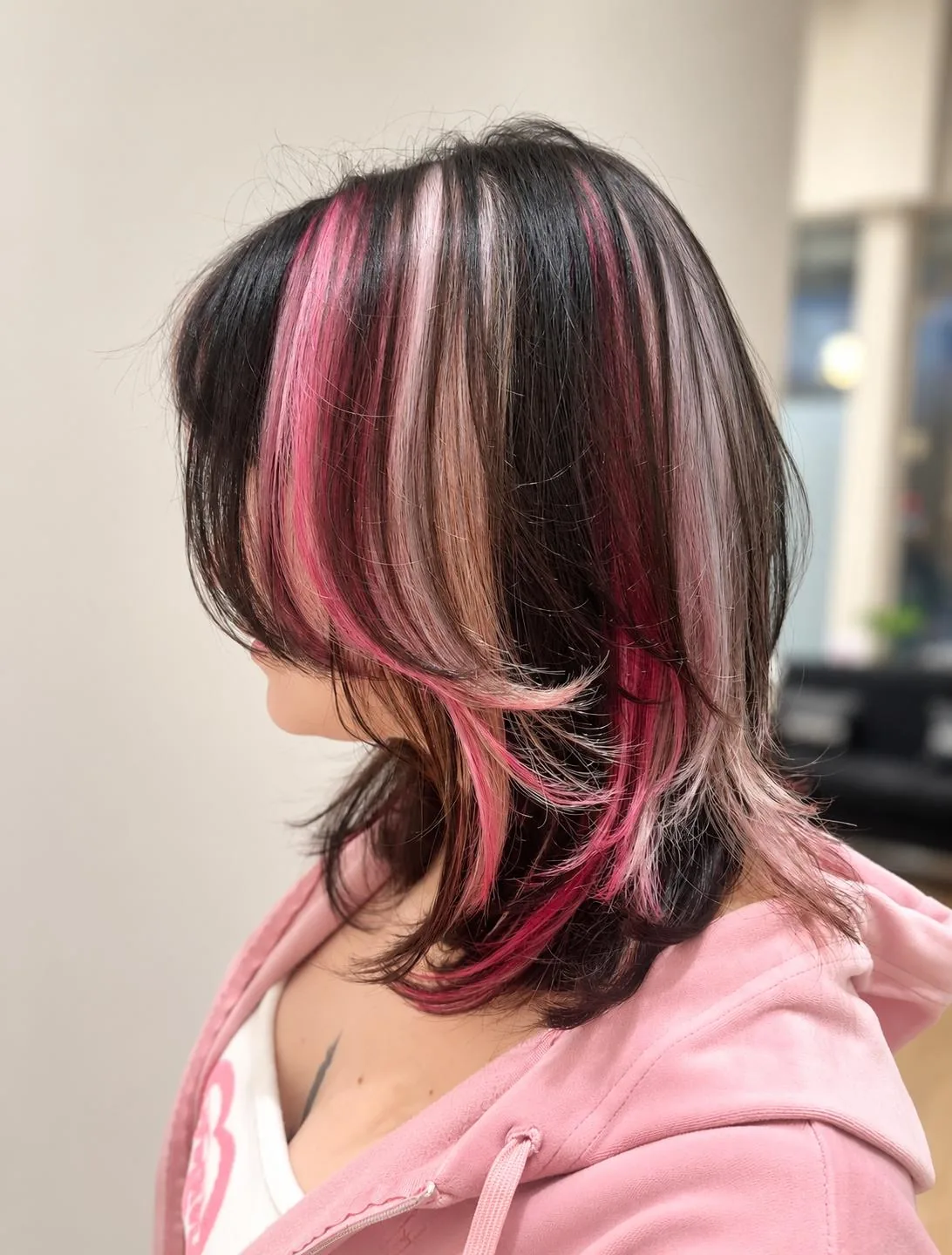 Dark bob with vivid pink face-framing highlights