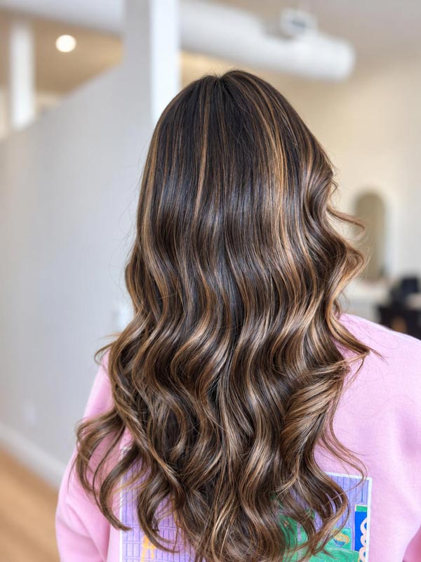 Smooth brown hair with subtle caramel highlights