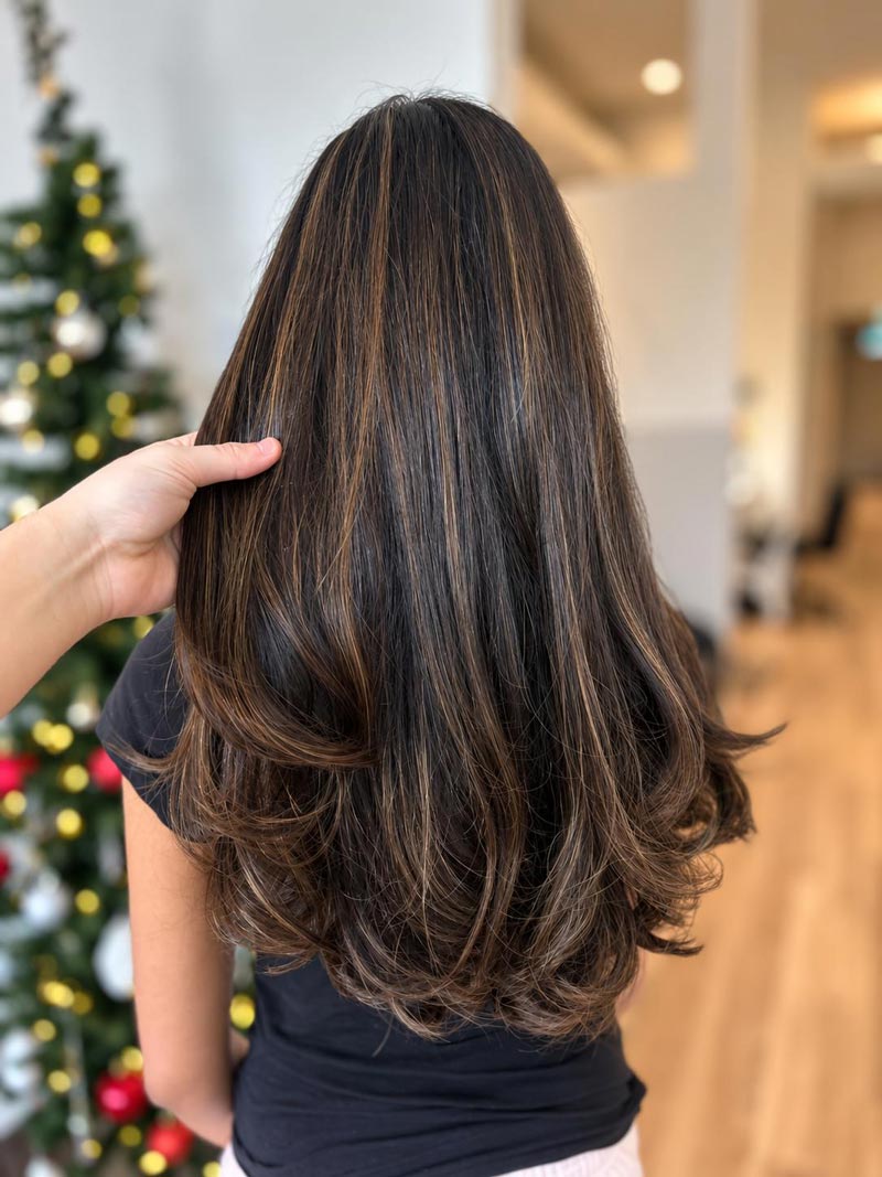 Long brunette waves with soft blonde dimension